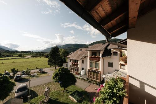 a view from the balcony of a house with a yard at BookNassfeld in Tröpolach