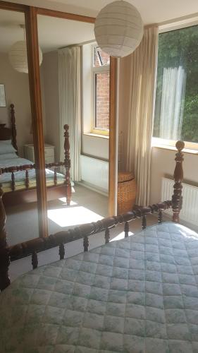 a bedroom with a bed and a large window at 38 Cambanks 2 double bedroom apartment in Cambridge
