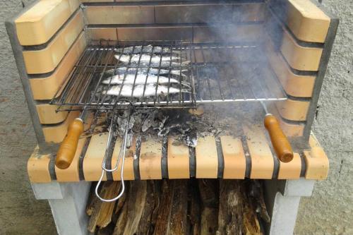 a grill with a bunch of food on it at Palheirinho in Zimbreira