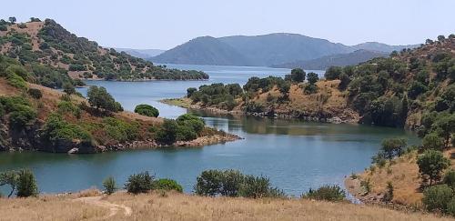 a view of a river with mountains in the background at Is Antas in Orroli
