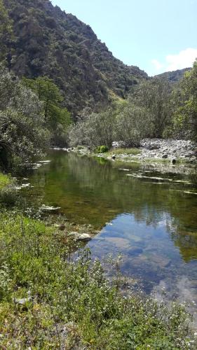 a river with a mountain in the background at Is Antas in Orroli