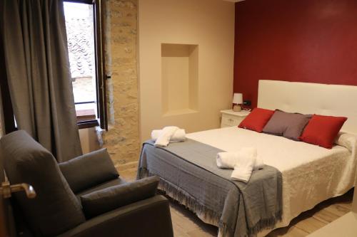 a bedroom with a bed and a chair at Casa Rural Tarayuela in Cantavieja