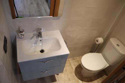 a bathroom with a white sink and a toilet at Casa Rural Tarayuela in Cantavieja