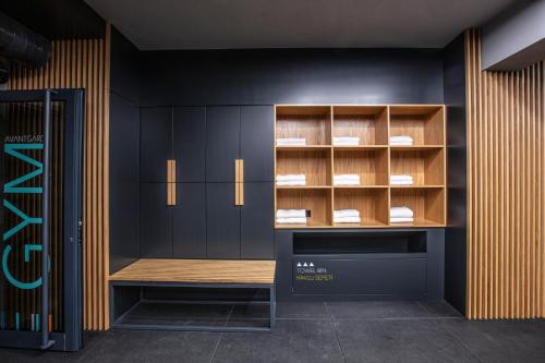 a room with black cabinets and a wooden bench at Ilayda Avantgarde Hotel in Kusadası