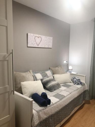 a bedroom with a bed with a heart picture on the wall at Apartamento céntrico en León in León