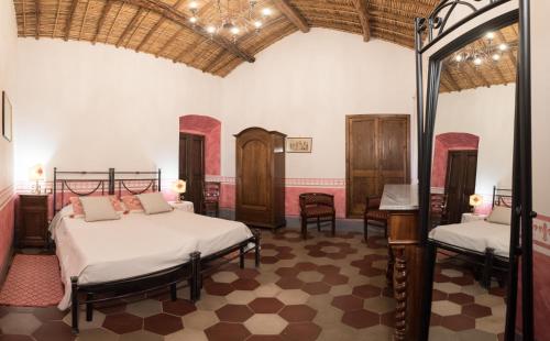 a bedroom with two beds in a room at Hotel Anticos Palathos in Orosei