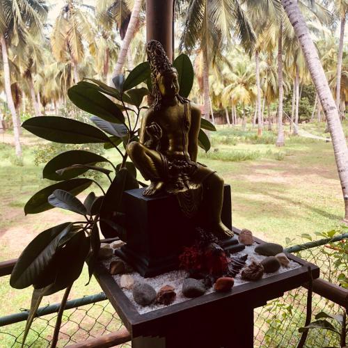 a statue of a woman sitting on a table at Wind Blend Kite Resort in Kalpitiya