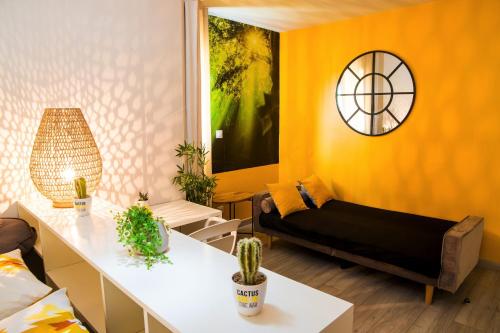 a living room with yellow walls and a couch at MANGANAO LOFTS INN Bord de Mer in Saint-François
