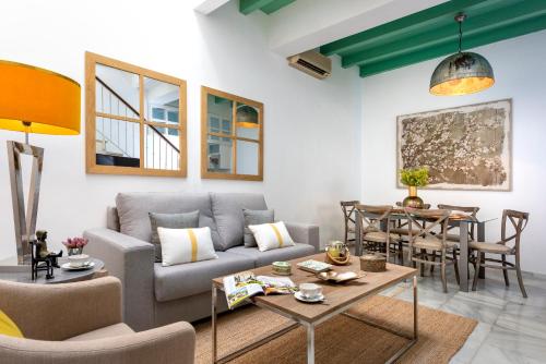 a living room with a couch and a table at Genteel Home Pajaritos in Seville