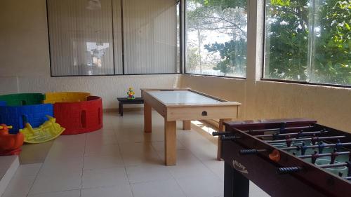a room with a table and some colorful chairs at Pousada do Albatroz in Cabo Frio