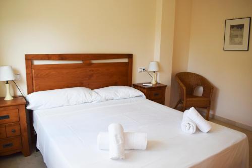 a bedroom with two beds with white sheets and towels at Anacasa Vora Golf 3 Playa Rabdells DUP3027 in Oliva