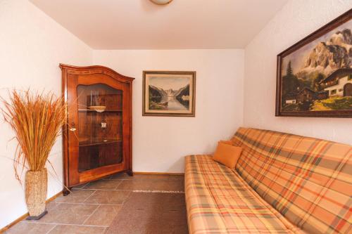 a living room with a couch and a cabinet at POHORJE HOUSE 2 FOUR APPARTMETNS in Oplotnica