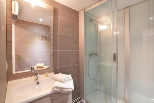 a bathroom with a shower and a sink at Résidence Néméa La Soulane in Loudenvielle