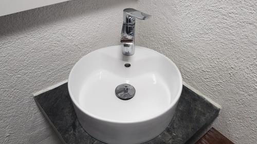 a white sink with a silver faucet in a bathroom at Chalet am Park in Piesendorf