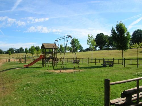 a playground with a slide in a field at Chaillac Bed & Breakfast in Chaillac