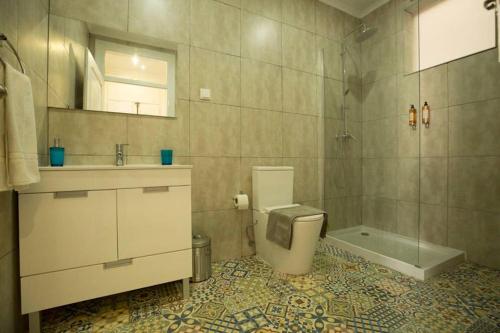 a bathroom with a toilet and a sink and a tub at Olá Lisbon - Príncipe Real VII in Lisbon