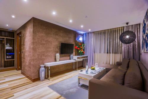 a living room with a couch and a tub at SBN Suite Hôtel in Tangier
