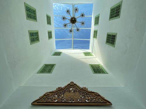 a room with a ceiling with a clock in it at Dar El Kif - La Marsa in La Marsa