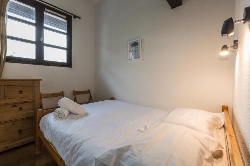 a small bedroom with a bed and a window at Apartment Jonquille 3 in Chamonix