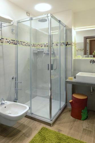 a bathroom with a glass shower and a sink at Hotel Sempione in Milan