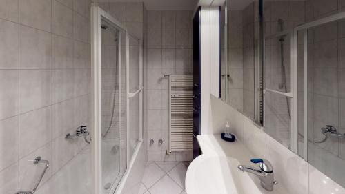 a bathroom with a tub and a sink and a shower at Unique Serviced Living @ Basel Old Town (0171) in Basel