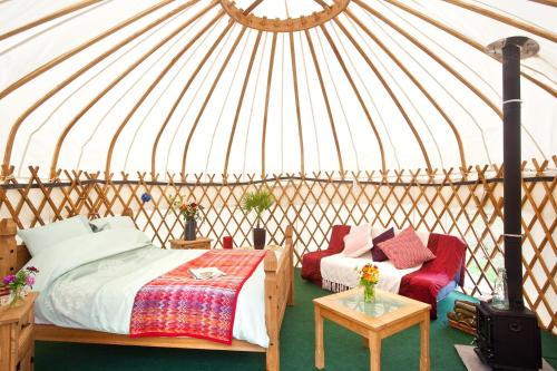 a yurt bedroom with two beds and a table at Portsalon Luxury Camping in Portsalon