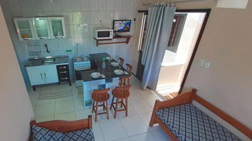 an aerial view of a small kitchen with stools at Loca da Lagosta in Barra Grande