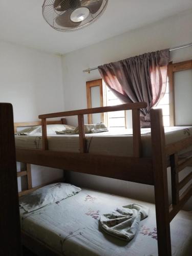 two bunk beds in a room with a window at Casa Madrigueña in Rincón