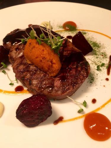 a plate of food with a piece of meat and sauce at Castle Grove Country House Hotel in Letterkenny