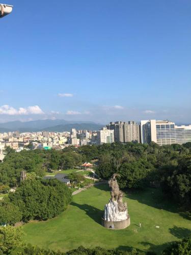 a statue in a park with a city in the background at 星霖之家 in Taichung