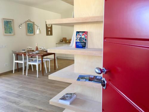 a kitchen and dining room with a red refrigerator at Barcuzzi in Barcuzzi