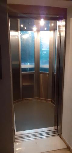 a glass shower in a room with a window at Hotel Themisto in Nikolaíika