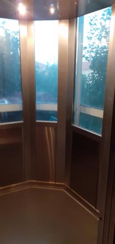 a room with two windows in a room at Hotel Themisto in Nikolaíika
