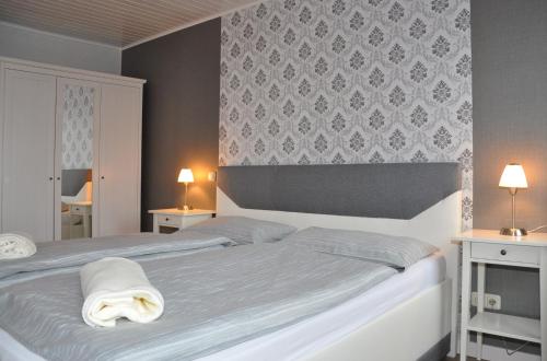 a bedroom with a bed with two lamps on it at Landhaus Bruckner in Bad Alexandersbad
