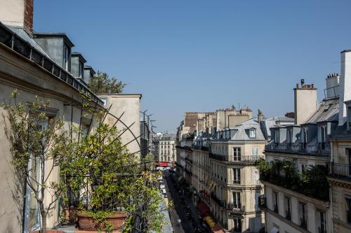 a view of a city street with buildings at Hôtel Mansart - Esprit de France in Paris