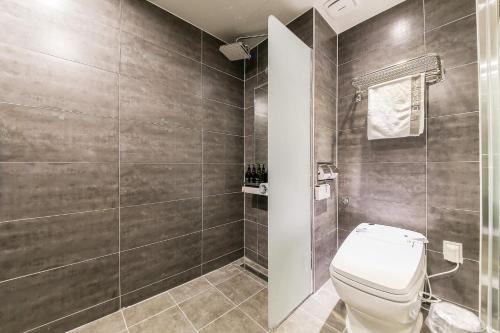 a bathroom with a toilet and a walk in shower at Docking Hotel in Gimpo