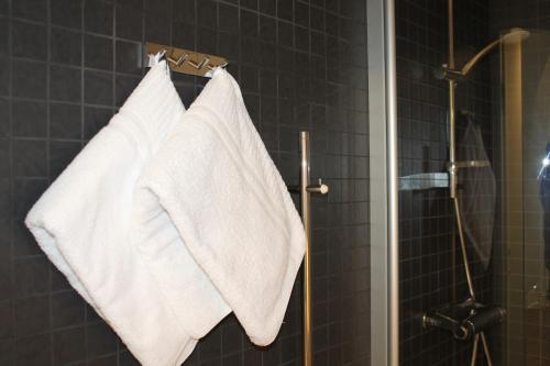 a bathroom with white towels hanging on a rack at Hotel Torslanda in Torslanda