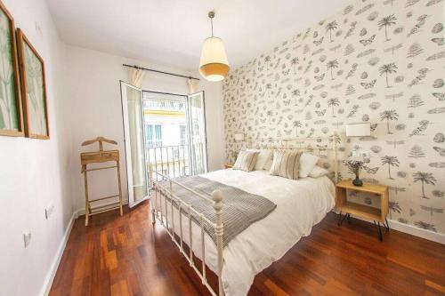 1 dormitorio con 1 cama y papel pintado con motivos florales en Next to the Mushrooms, butterfly room, en Sevilla