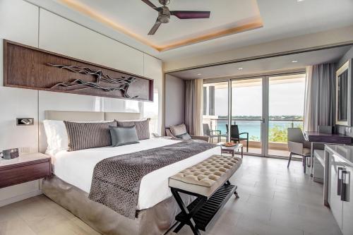 a bedroom with a large bed and a large window at Hideaway at Royalton Negril, An Autograph Collection All-Inclusive Resort - Adults Only in Negril