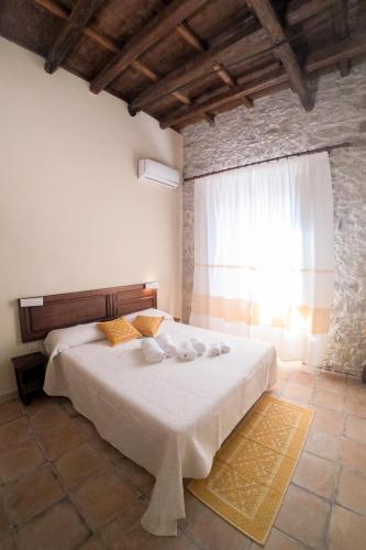 a bedroom with a white bed with a window at Villa Chiara in Villamar