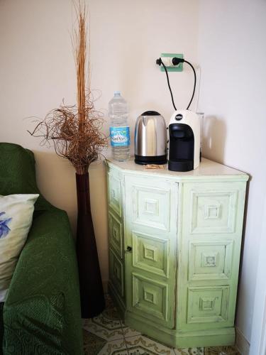 a green cabinet with a coffee maker on top of it at B&B L ORTENSIA in Bolsena
