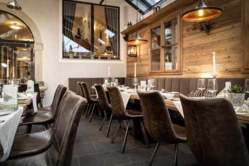 a restaurant with wooden walls and tables and chairs at Hotel-Gasthof Höttl in Deggendorf