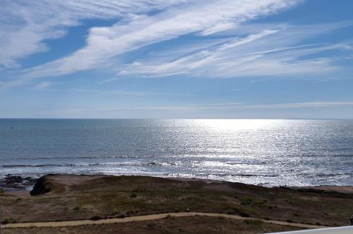 a view of the ocean with the sky and clouds at Hotel La Corniche in Saint-Hilaire-de-Riez