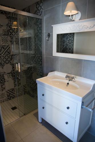 a bathroom with a sink and a shower at Appart-hôtel Chanzy / Angoulême in Angoulême