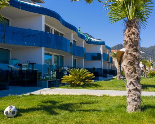 a soccer ball in the grass in front of a building at Barocco Wave Hotel in Skala Potamias