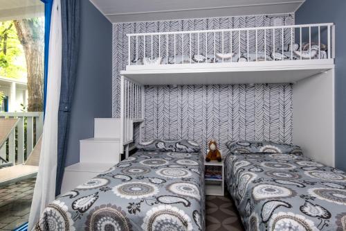 a bed in a bedroom with blue walls at Camping Union Lido in Cavallino-Treporti