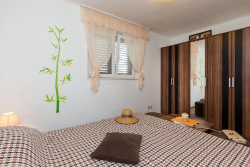 a bedroom with a bed and a window at Apartments Green Harmony in Mlini