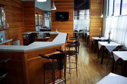 a bar in a restaurant with tables and chairs at São Joaquim Park Hotel in São Joaquim