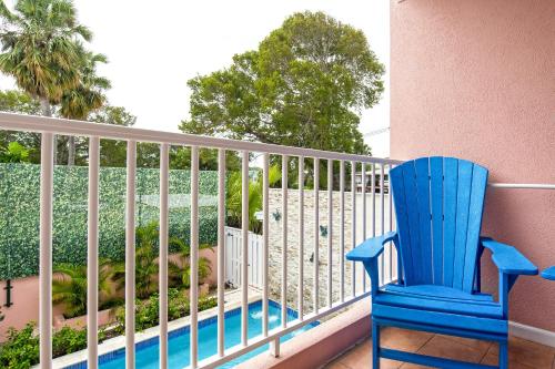 a blue chair sitting in front of a fence at Butterfly Beach Hotel in Christ Church
