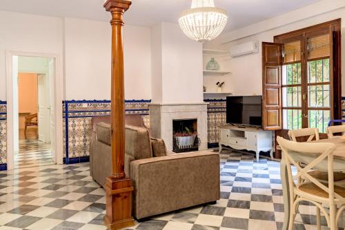 a living room with a couch and a fireplace at PATIOS DE GARCIA LORCA in Granada